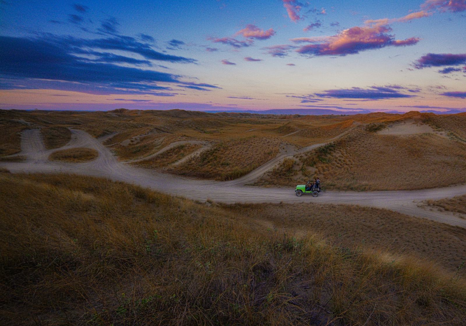 The La Paz sand dunes at dusk, a track winding through the ridges.